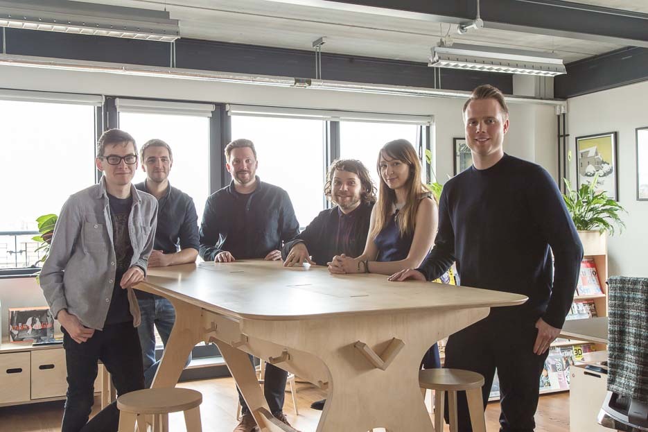 The team gathered around the breakout table